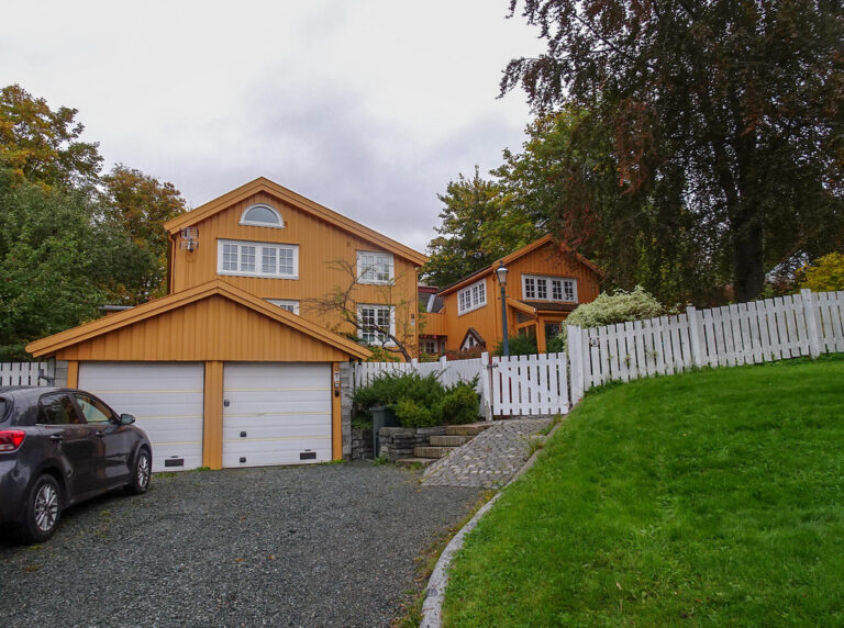 Gravel driveway separated from the lawn by a raised stone edging strip